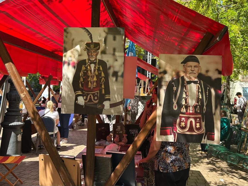 Ovako izgleda štand Hrvata iz Crne Gore na kojem dominiraju fotografije znamenitih bokeljskih mornara iz vremena Mletačke Republike kad su tamošnji Hrvati plovili pod tom zastavom i borili se za Mletke